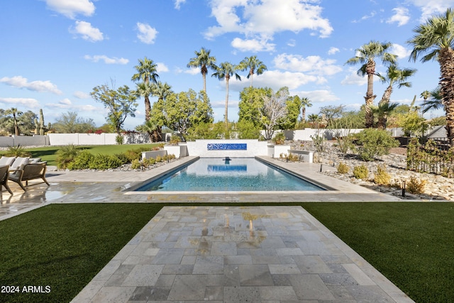 view of pool with a patio and a yard