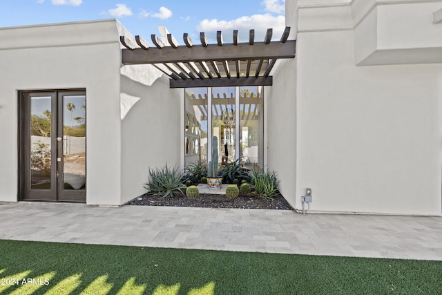 view of exterior entry with french doors and a patio