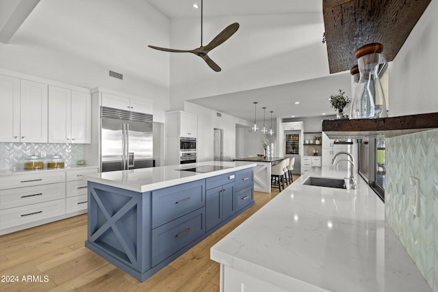 kitchen with white cabinets, a spacious island, and appliances with stainless steel finishes