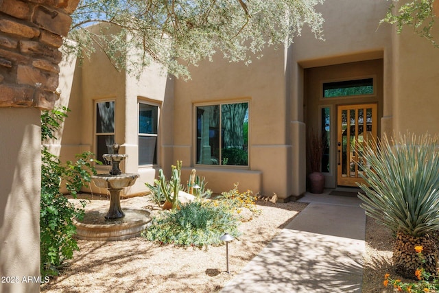 property entrance with stucco siding