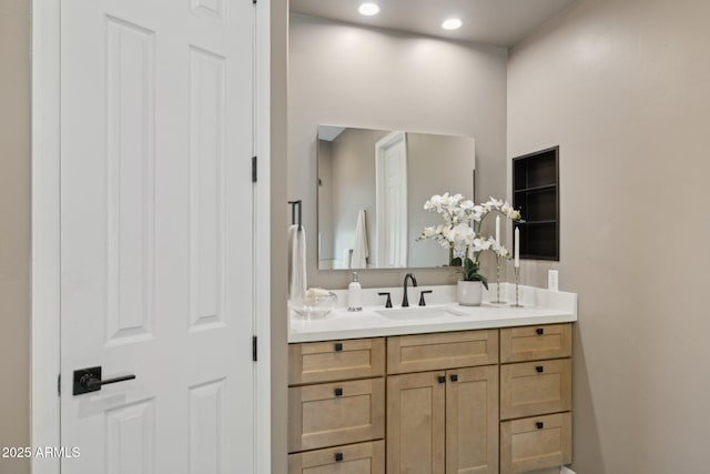bathroom featuring recessed lighting and vanity
