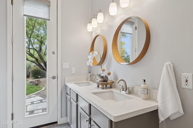 bathroom with double vanity, a wealth of natural light, and a sink