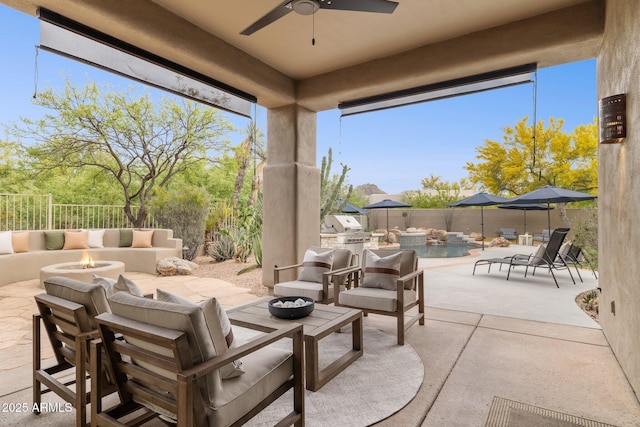 view of patio featuring an outdoor living space with a fire pit, grilling area, a fenced backyard, an outdoor kitchen, and a ceiling fan