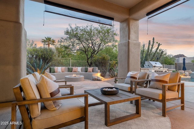 view of patio featuring an outdoor living space with a fire pit, exterior kitchen, and area for grilling