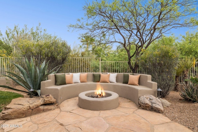 view of patio featuring fence and an outdoor fire pit