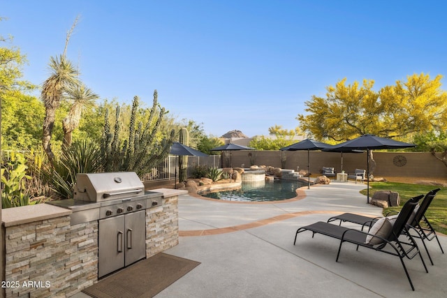 view of patio / terrace featuring a fenced backyard, a fenced in pool, exterior kitchen, and area for grilling