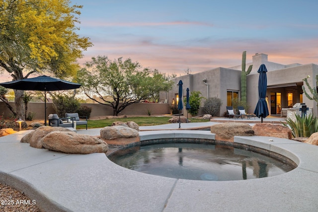 view of swimming pool featuring an in ground hot tub, fence, and a patio area