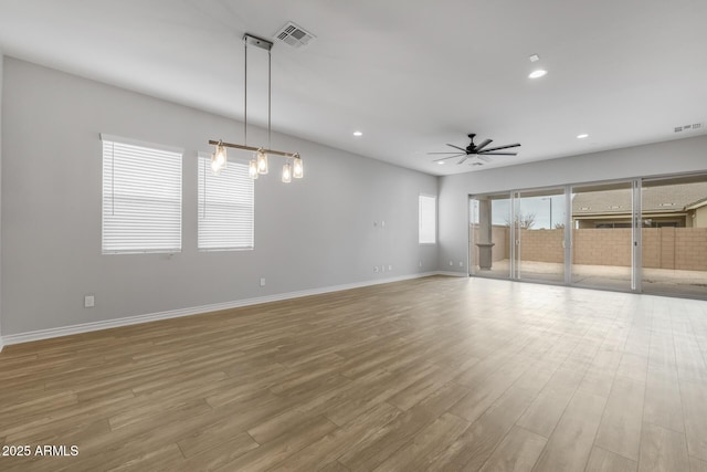 empty room featuring ceiling fan and light hardwood / wood-style floors