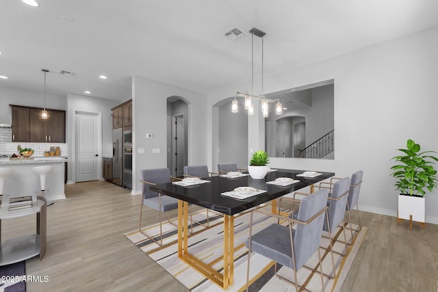 dining area featuring light wood-type flooring