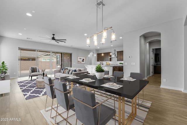 dining space with ceiling fan and light hardwood / wood-style floors