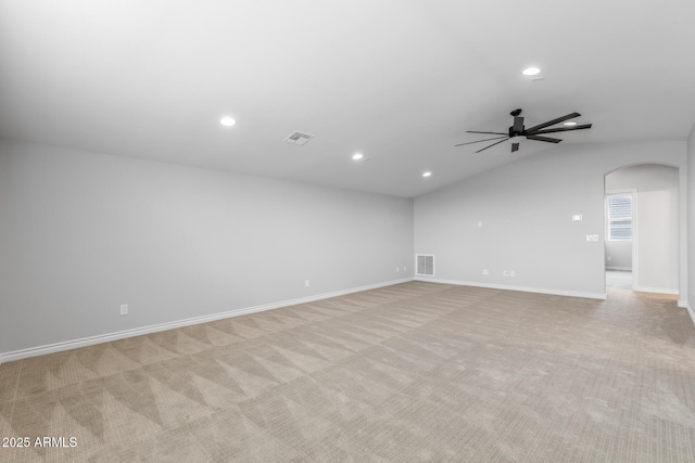 unfurnished room with ceiling fan, light carpet, and vaulted ceiling