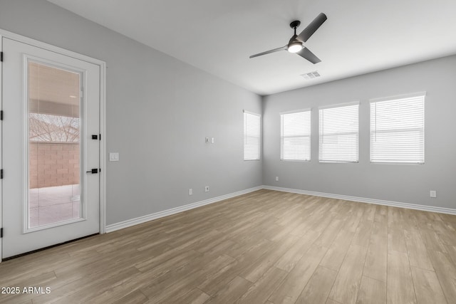 empty room featuring ceiling fan and light hardwood / wood-style flooring