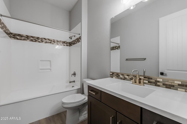 full bathroom with vanity, decorative backsplash, toilet, hardwood / wood-style flooring, and bathtub / shower combination