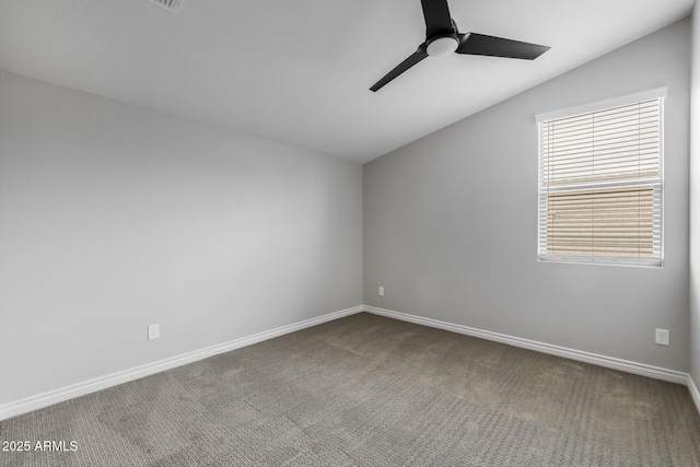 carpeted empty room featuring ceiling fan and vaulted ceiling