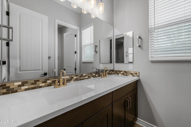 bathroom featuring tasteful backsplash and vanity