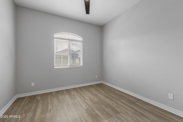 spare room with ceiling fan and light wood-type flooring