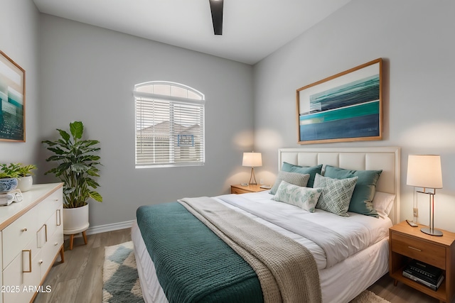 bedroom with ceiling fan and light hardwood / wood-style floors