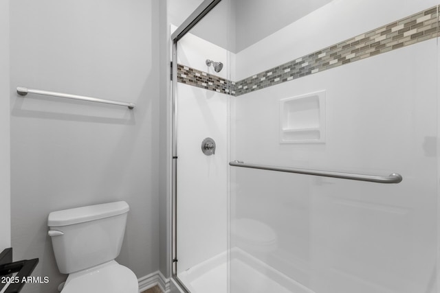 bathroom with toilet and walk in shower