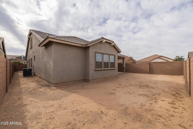 rear view of property featuring central air condition unit