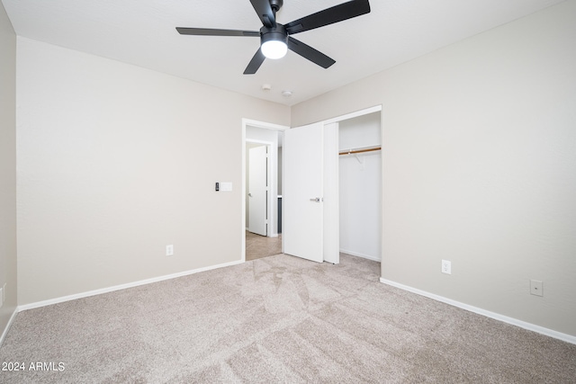 unfurnished bedroom featuring a closet, light carpet, and ceiling fan