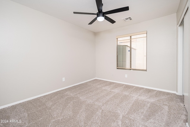 spare room featuring light carpet and ceiling fan