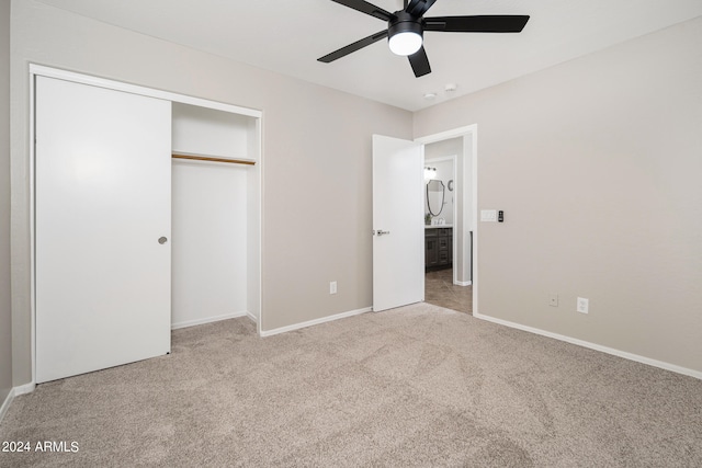 unfurnished bedroom featuring light colored carpet, a closet, and ceiling fan