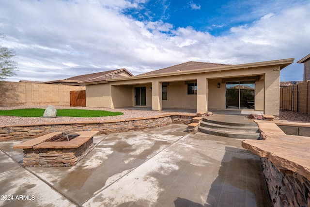 prairie-style house with an outdoor fire pit and a patio