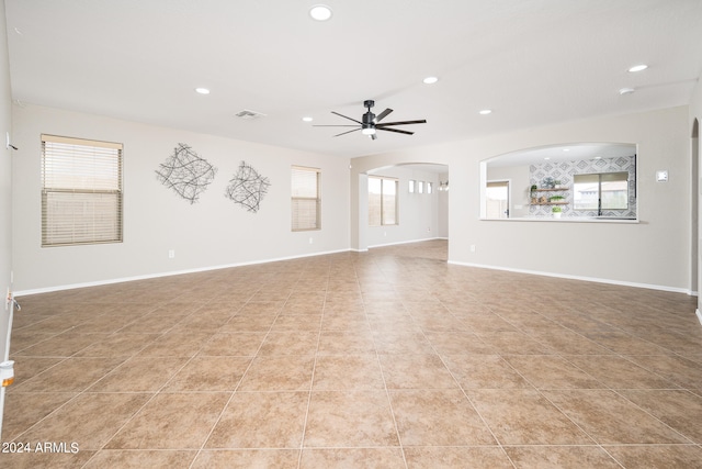 unfurnished living room with ceiling fan and light tile flooring