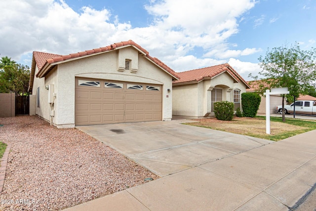 510 W Amoroso Dr, Gilbert, AZ 85233 - mediterranean / spanish home with an attached garage, a tiled roof, stucco siding, concrete driveway, and a gate