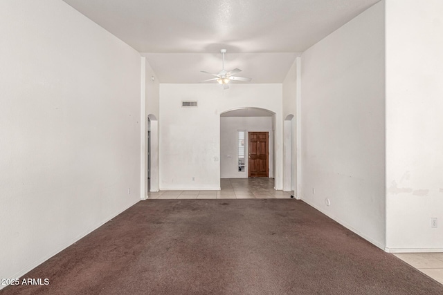 510 W Amoroso Dr, Gilbert, AZ 85233 - tiled spare room featuring arched walkways, ceiling fan, carpet flooring, and baseboards