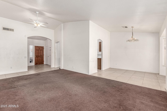 510 W Amoroso Dr, Gilbert, AZ 85233 - carpeted empty room with arched walkways, tile patterned flooring, ceiling fan, vaulted ceiling, and baseboards