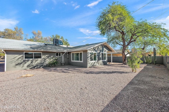 back of house with a fenced backyard