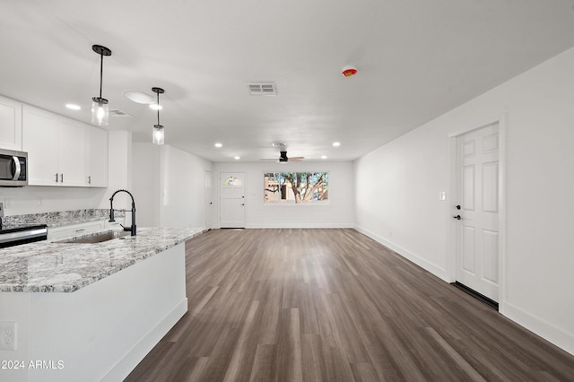 kitchen with dark wood-type flooring, a sink, visible vents, white cabinets, and appliances with stainless steel finishes