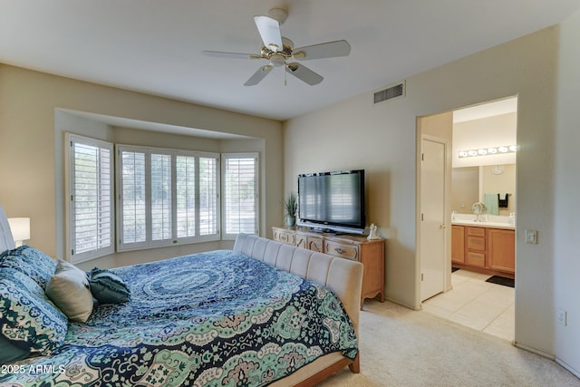 carpeted bedroom featuring connected bathroom and ceiling fan