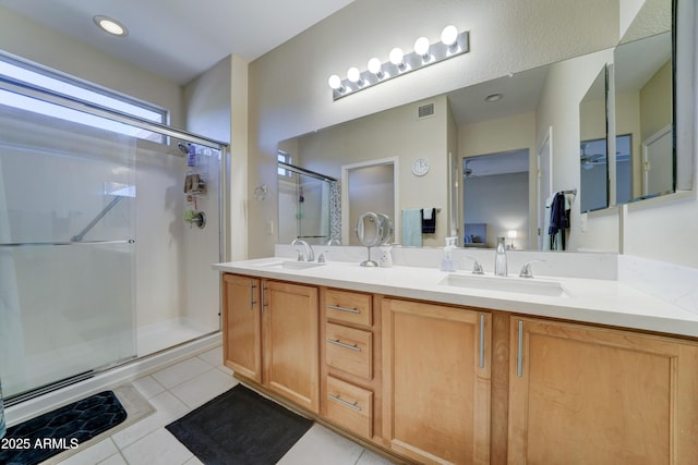 bathroom featuring vanity, a shower with shower door, and tile patterned floors