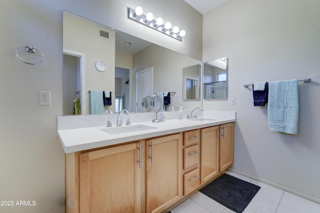 bathroom with vanity, tile patterned floors, and a shower with shower door