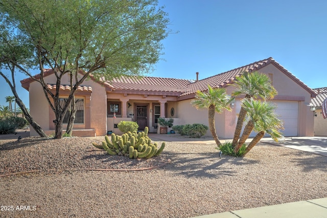 mediterranean / spanish-style home with a garage