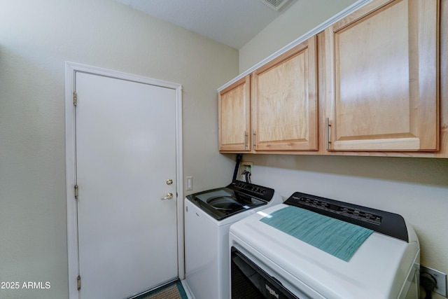 laundry room with cabinets and washer and dryer