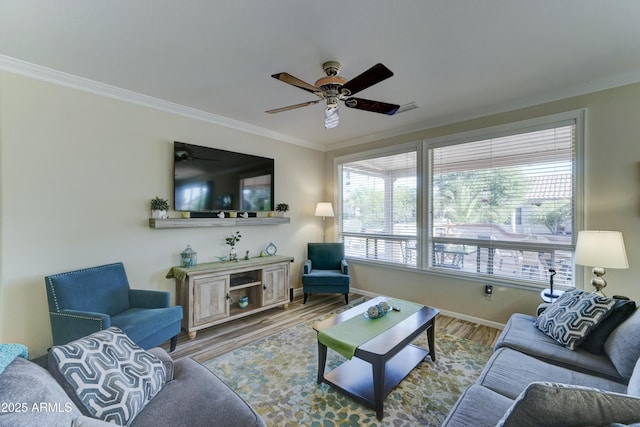 living room with hardwood / wood-style floors, ornamental molding, and ceiling fan