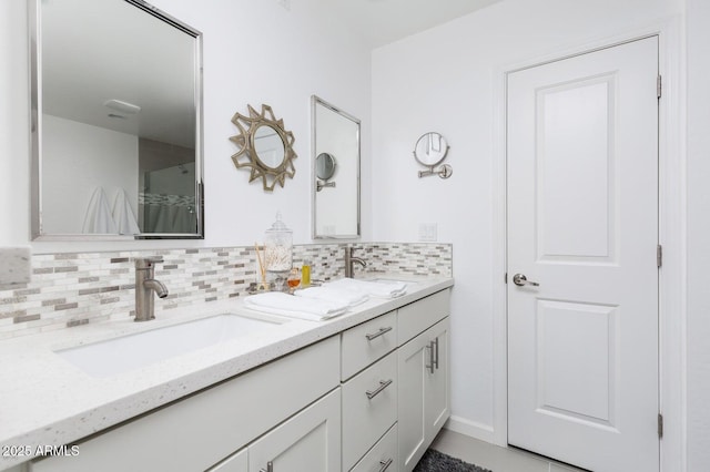 full bath featuring double vanity, decorative backsplash, and a sink