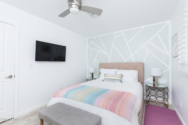 bedroom featuring wood finished floors, baseboards, and ceiling fan