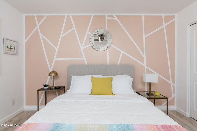 bedroom featuring wood finished floors and baseboards