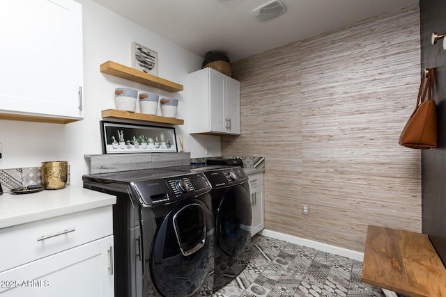 laundry area featuring washer and dryer and cabinet space