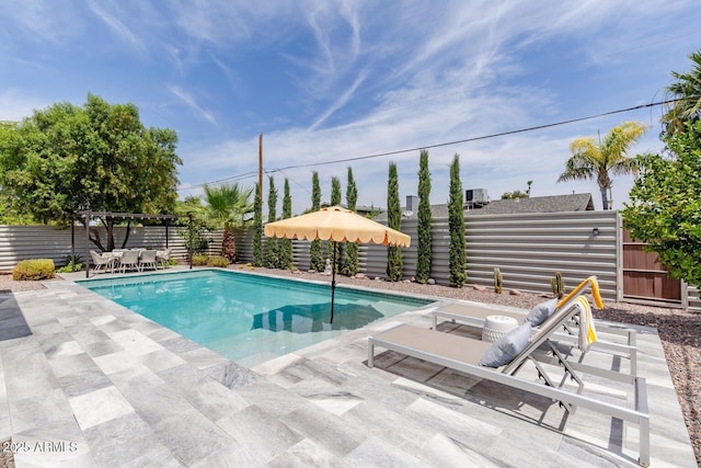 view of swimming pool featuring a fenced backyard, a fenced in pool, and a patio
