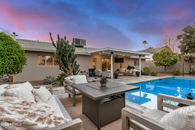 rear view of property featuring stucco siding, an outdoor living space, a patio, cooling unit, and an outdoor pool