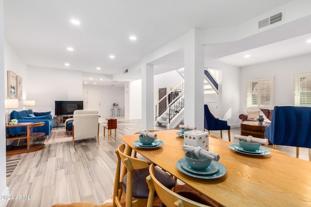 dining space with stairs, light wood-style flooring, visible vents, and recessed lighting