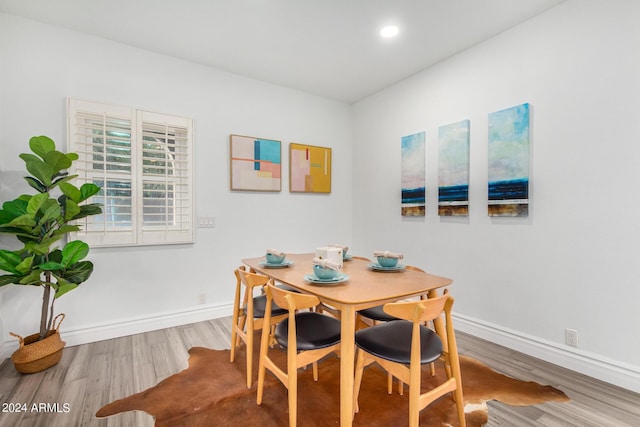 dining area featuring recessed lighting, baseboards, and wood finished floors