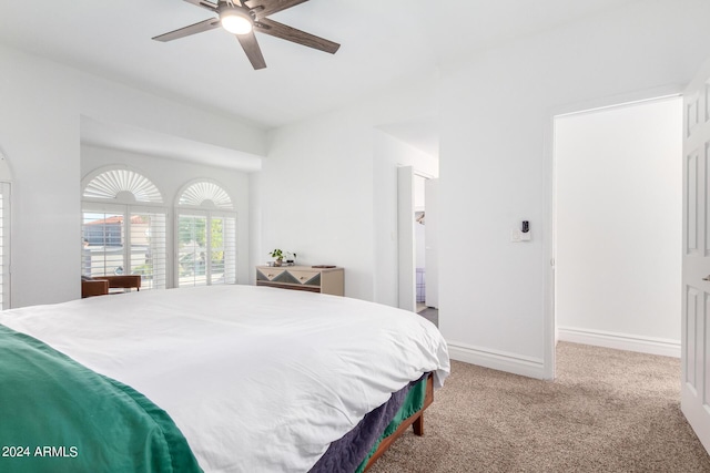 carpeted bedroom featuring ceiling fan and baseboards