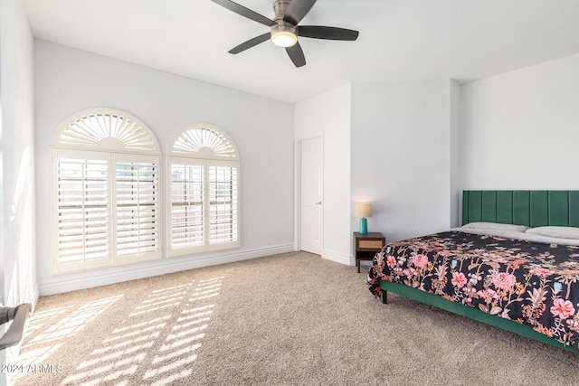 bedroom featuring ceiling fan, baseboards, and carpet flooring