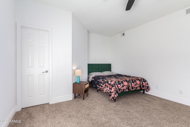 bedroom featuring carpet floors, baseboards, visible vents, and ceiling fan